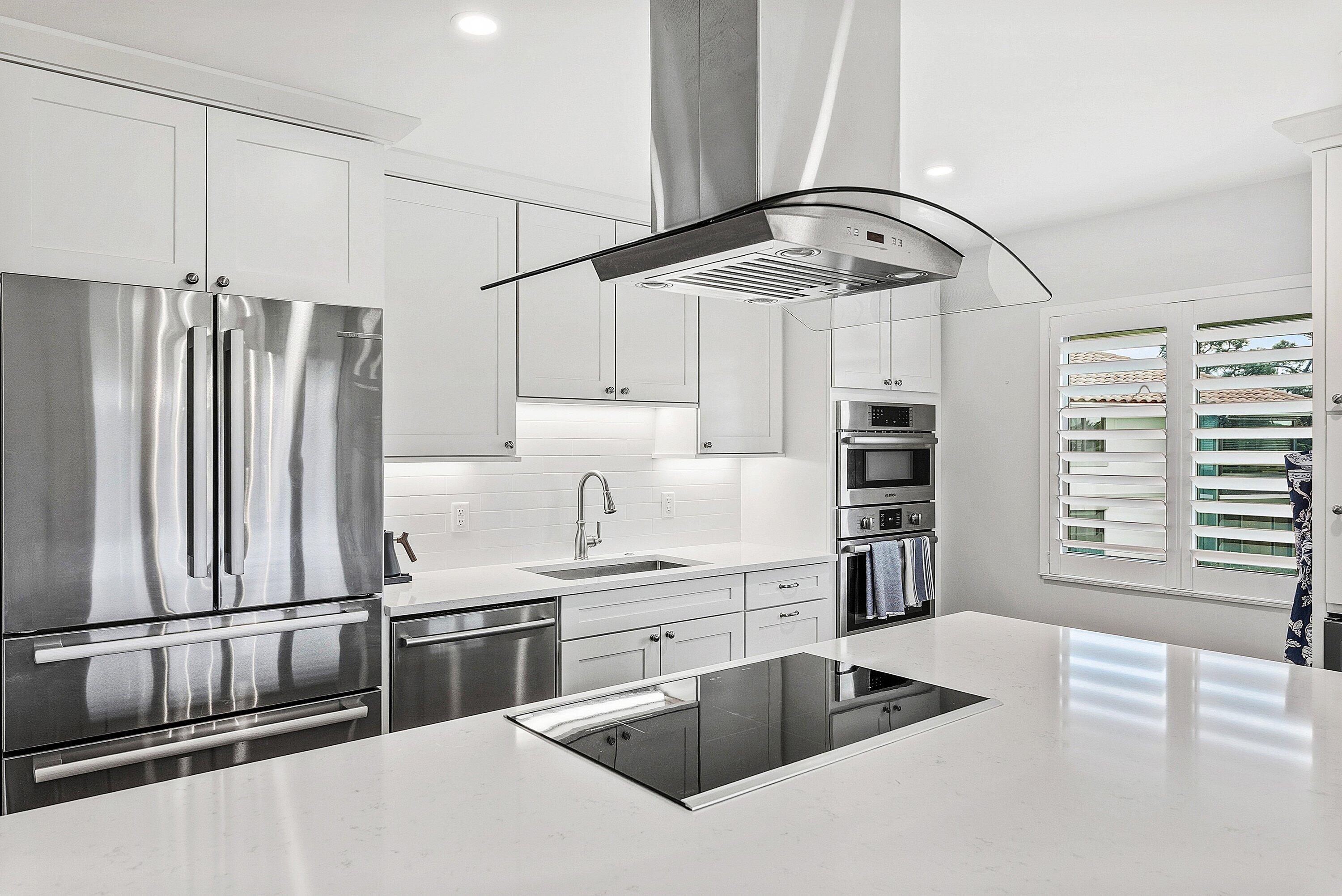 10157 Quail Covey Road, Unit HIBISCUS N Boynton Beach, FL 33436 - Photo 15 of 52 a kitchen with stainless steel appliances granite countertop a sink and a refrigerator