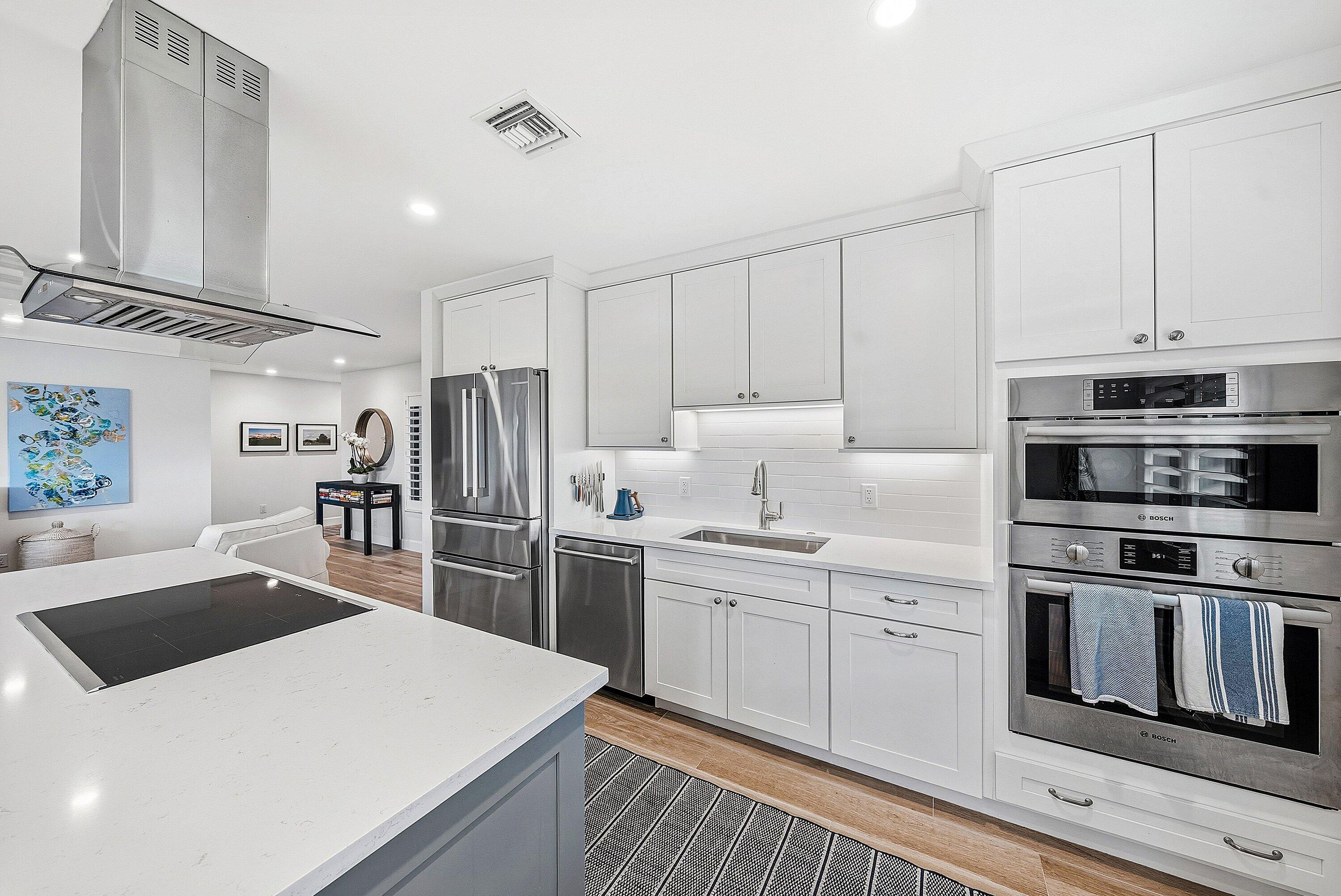 10157 Quail Covey Road, Unit HIBISCUS N Boynton Beach, FL 33436 - Photo 18 of 52 a kitchen with appliances a sink and cabinets