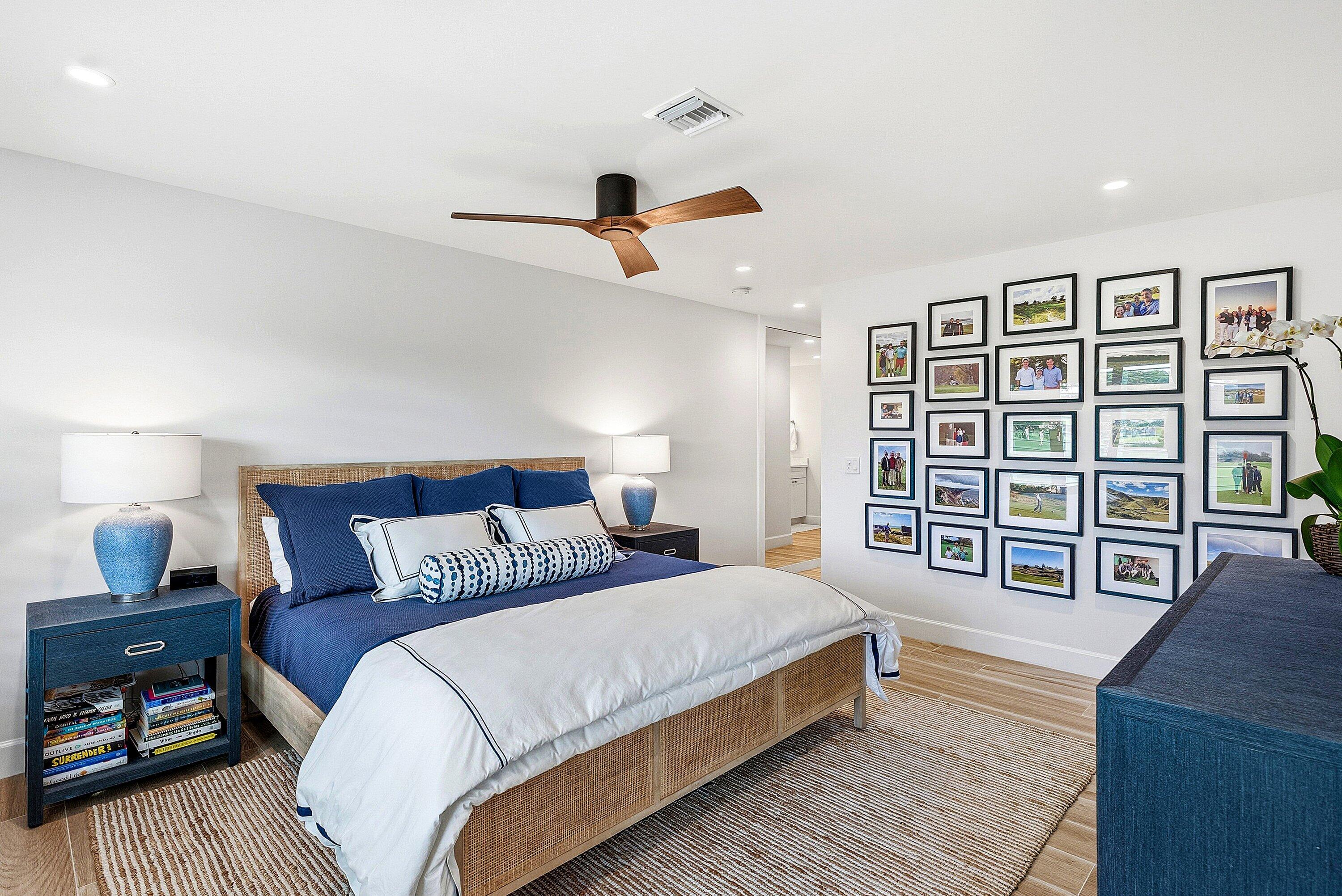 10157 Quail Covey Road, Unit HIBISCUS N Boynton Beach, FL 33436 - Photo 20 of 52 a bedroom with a large bed a chandelier and a window