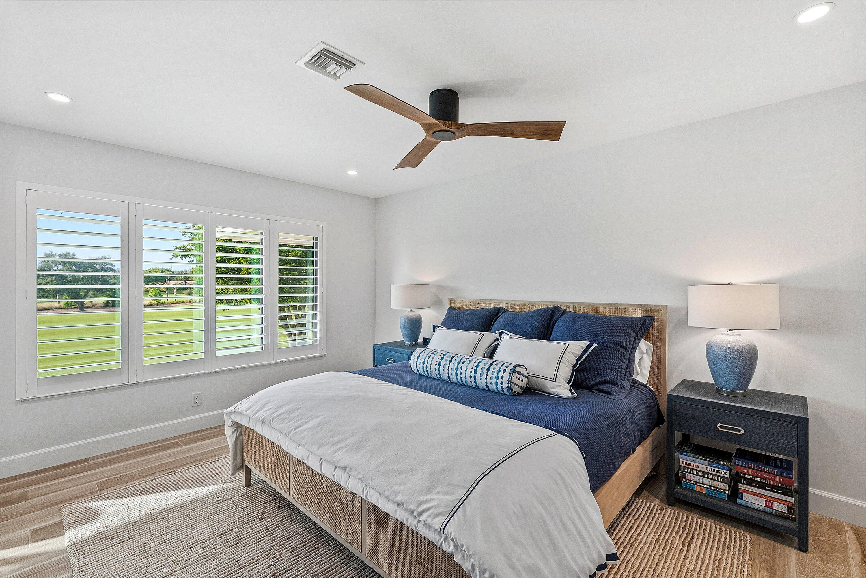 10157 Quail Covey Road, Unit HIBISCUS N Boynton Beach, FL 33436 - Photo 21 of 52 a bedroom with a bed a couch and a window