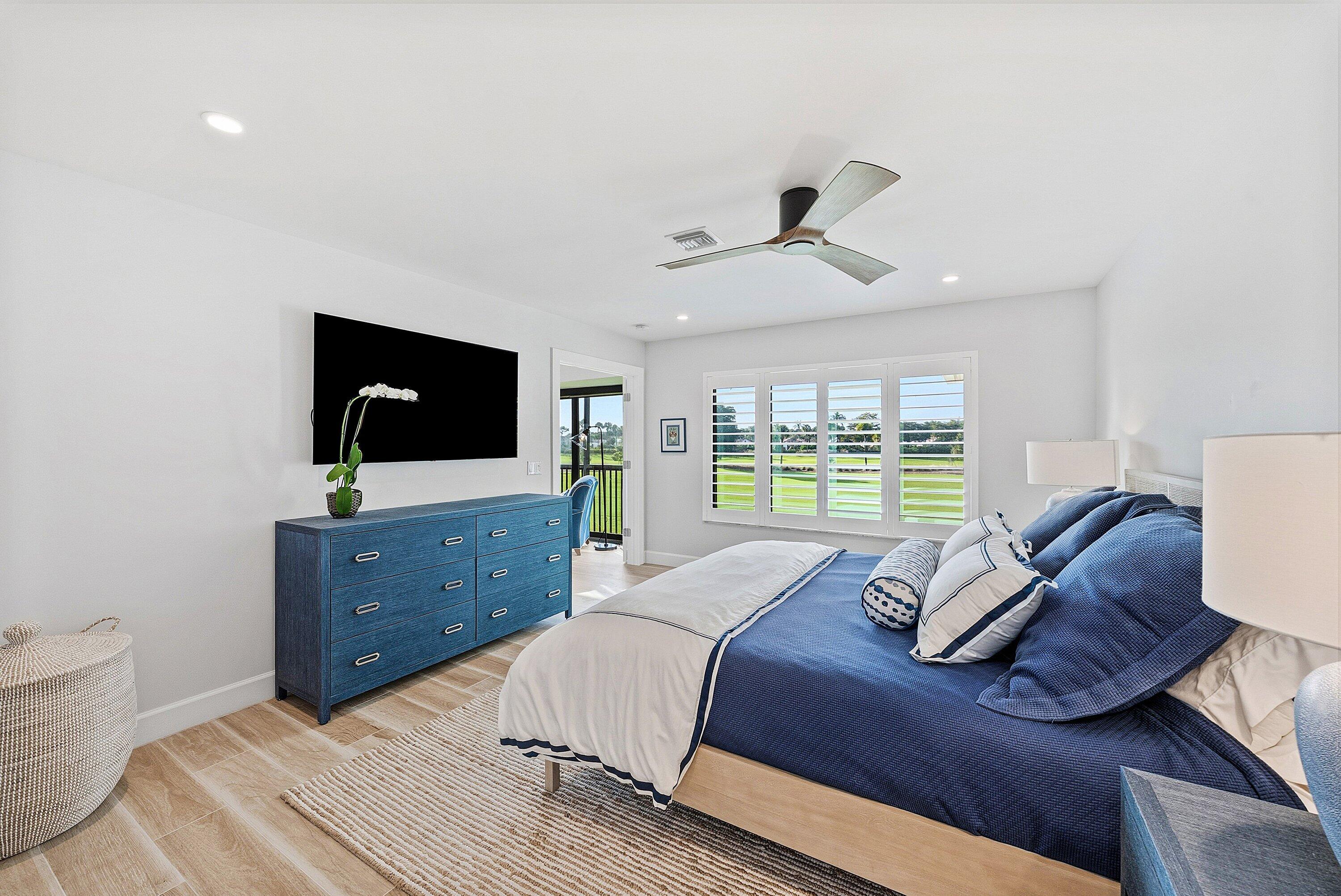 10157 Quail Covey Road, Unit HIBISCUS N Boynton Beach, FL 33436 - Photo 22 of 52 a bedroom with a bed window and a flat screen tv