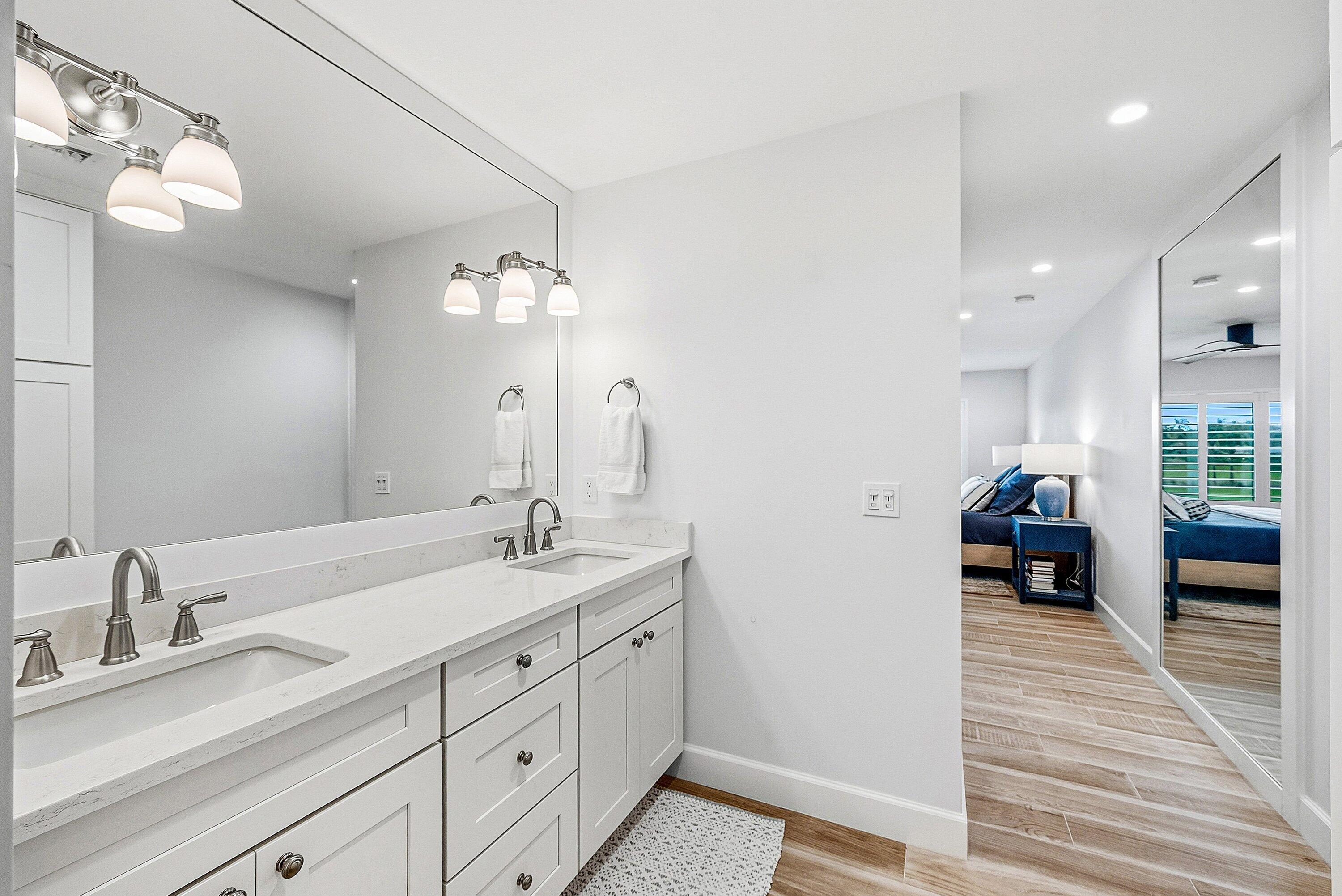 10157 Quail Covey Road, Unit HIBISCUS N Boynton Beach, FL 33436 - Photo 25 of 52 a en suite bathroom with double sink and a large mirror