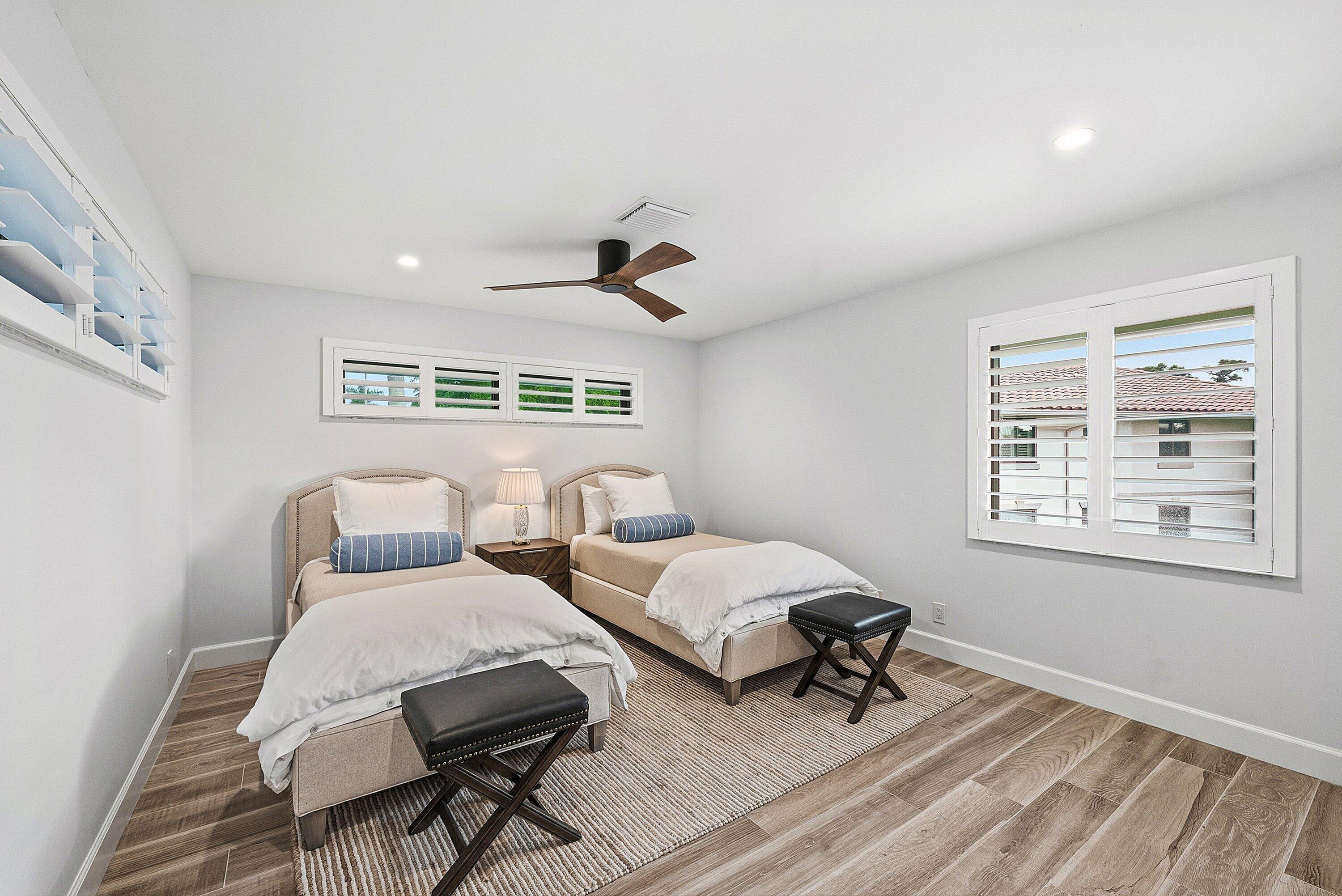10157 Quail Covey Road, Unit HIBISCUS N Boynton Beach, FL 33436 - Photo 26 of 52 a bedroom with two beds and a window