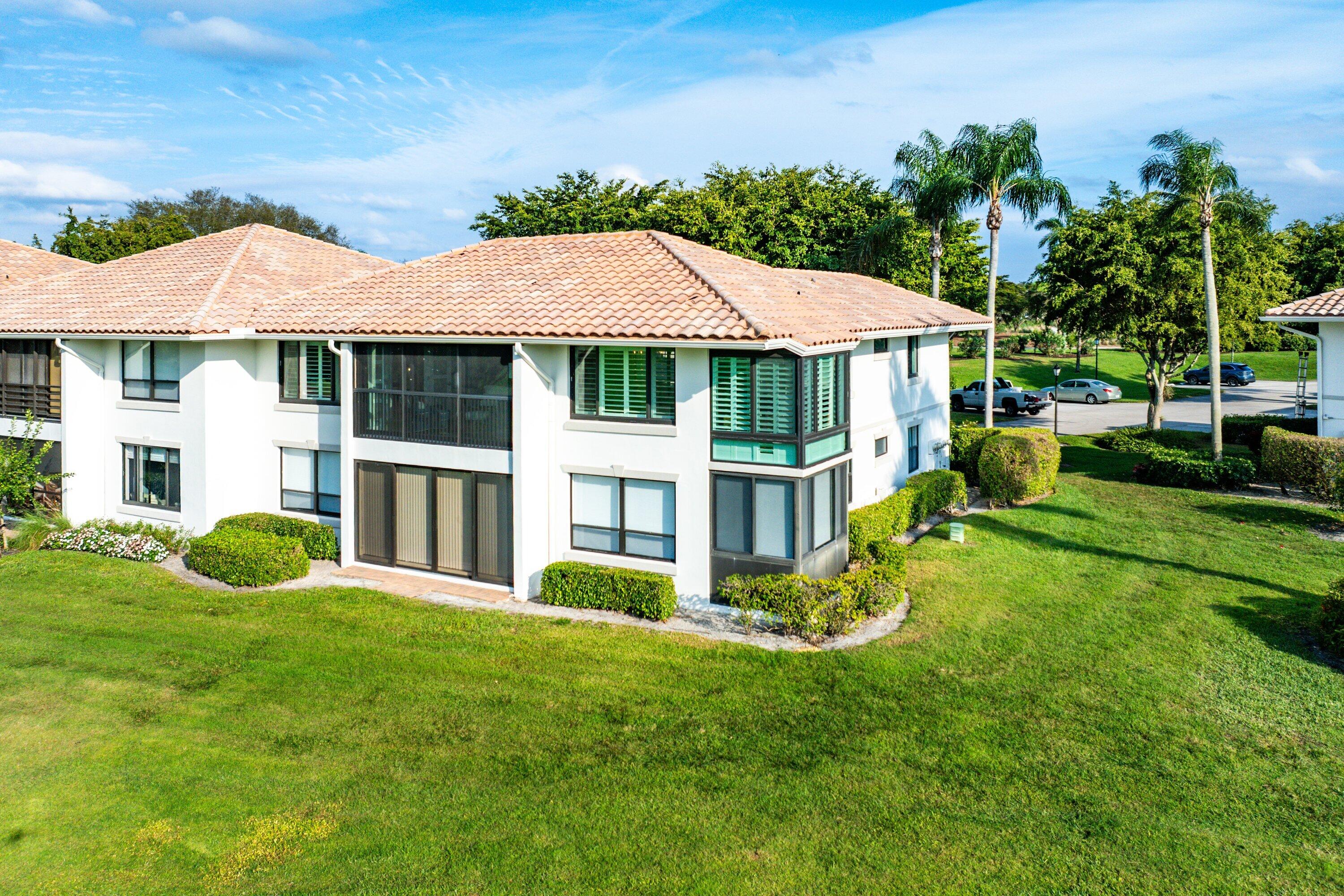 10157 Quail Covey Road, Unit HIBISCUS N Boynton Beach, FL 33436 - Photo 34 of 52 a view of a house with backyard and porch