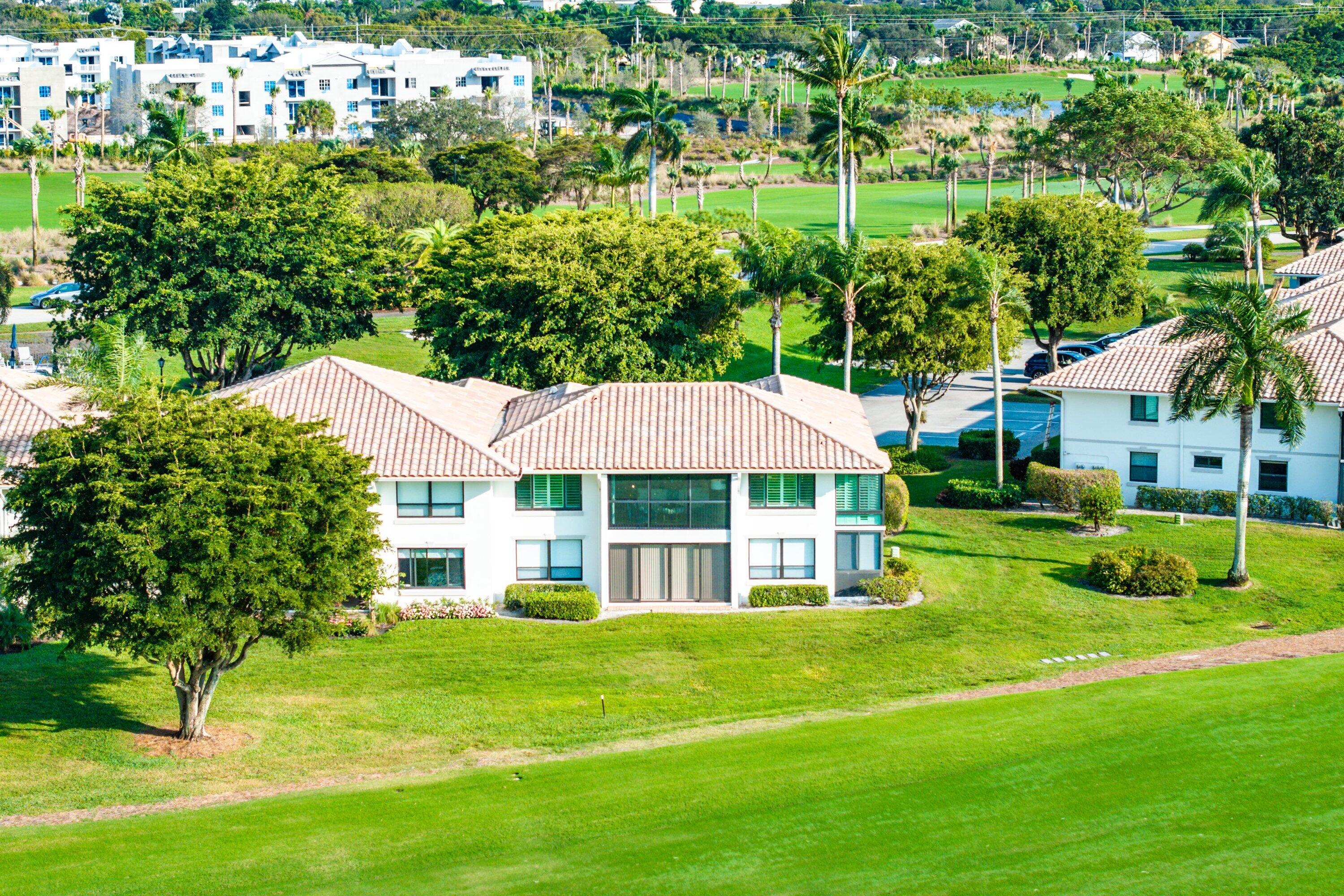 10157 Quail Covey Road, Unit HIBISCUS N Boynton Beach, FL 33436 - Photo 35 of 52 a house view with a garden space
