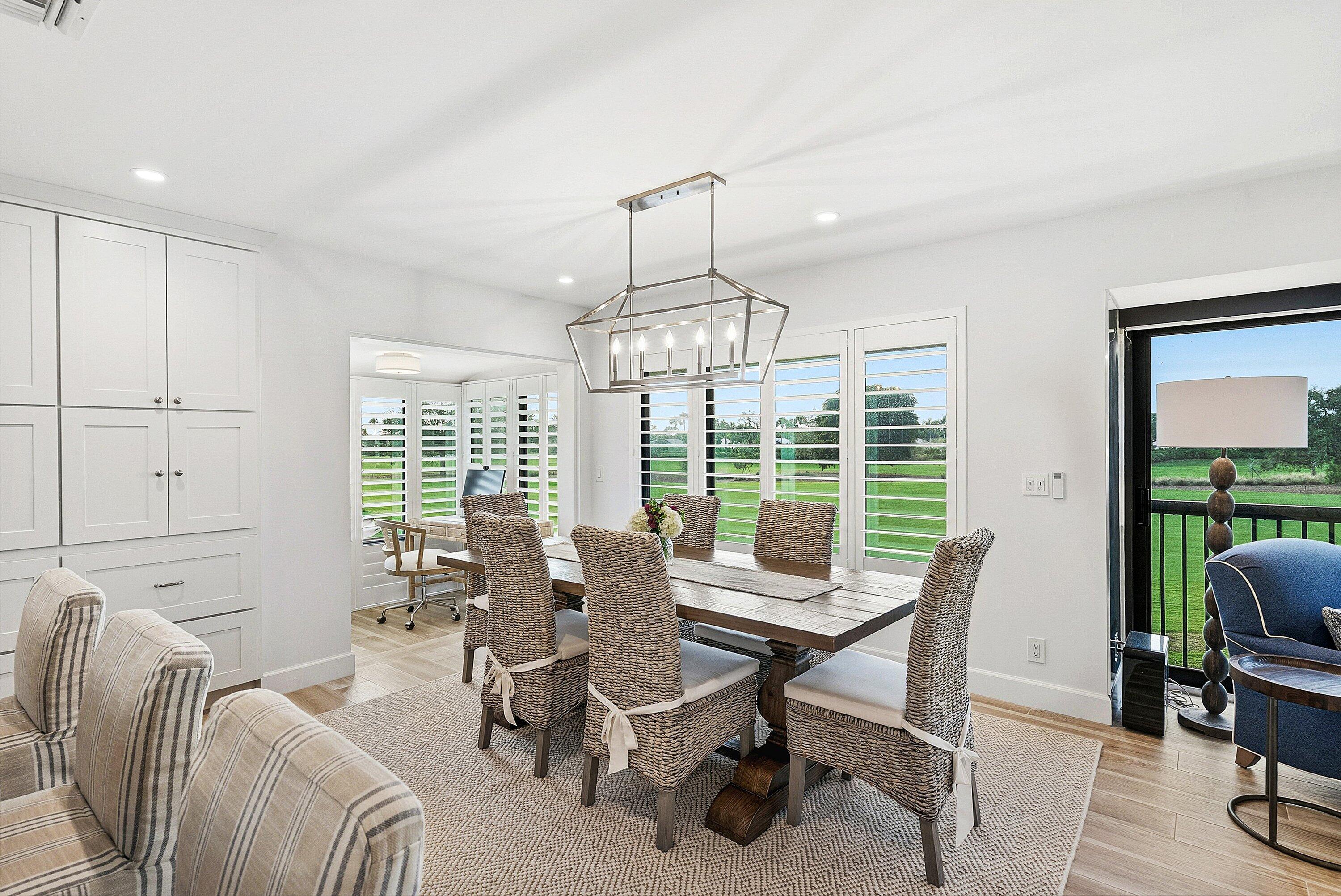 10157 Quail Covey Road, Unit HIBISCUS N Boynton Beach, FL 33436 - Photo 4 of 52 a dining room with furniture a chandelier and window