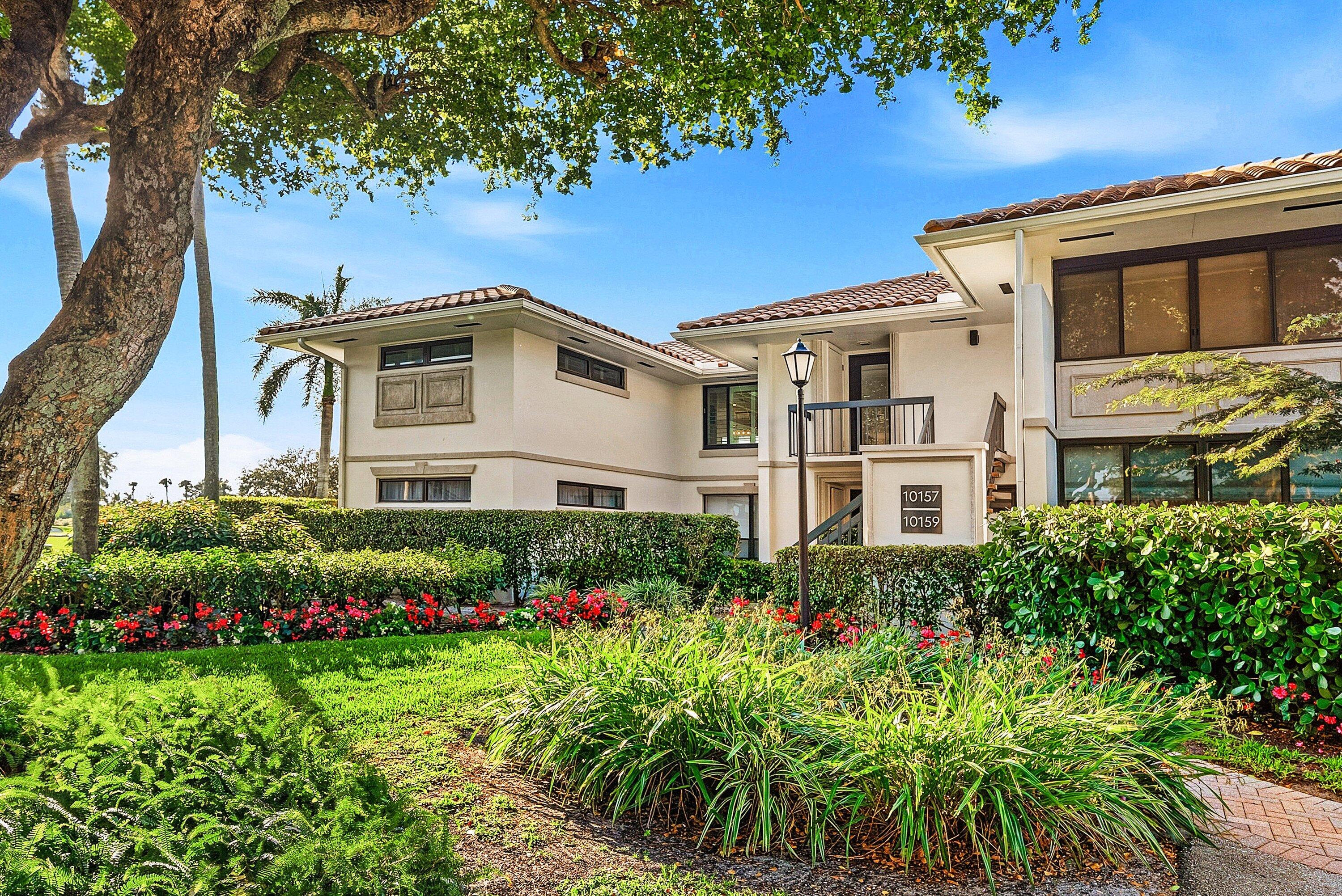 10157 Quail Covey Road, Unit HIBISCUS N Boynton Beach, FL 33436 - Photo 41 of 52 a front view of a house with a yard