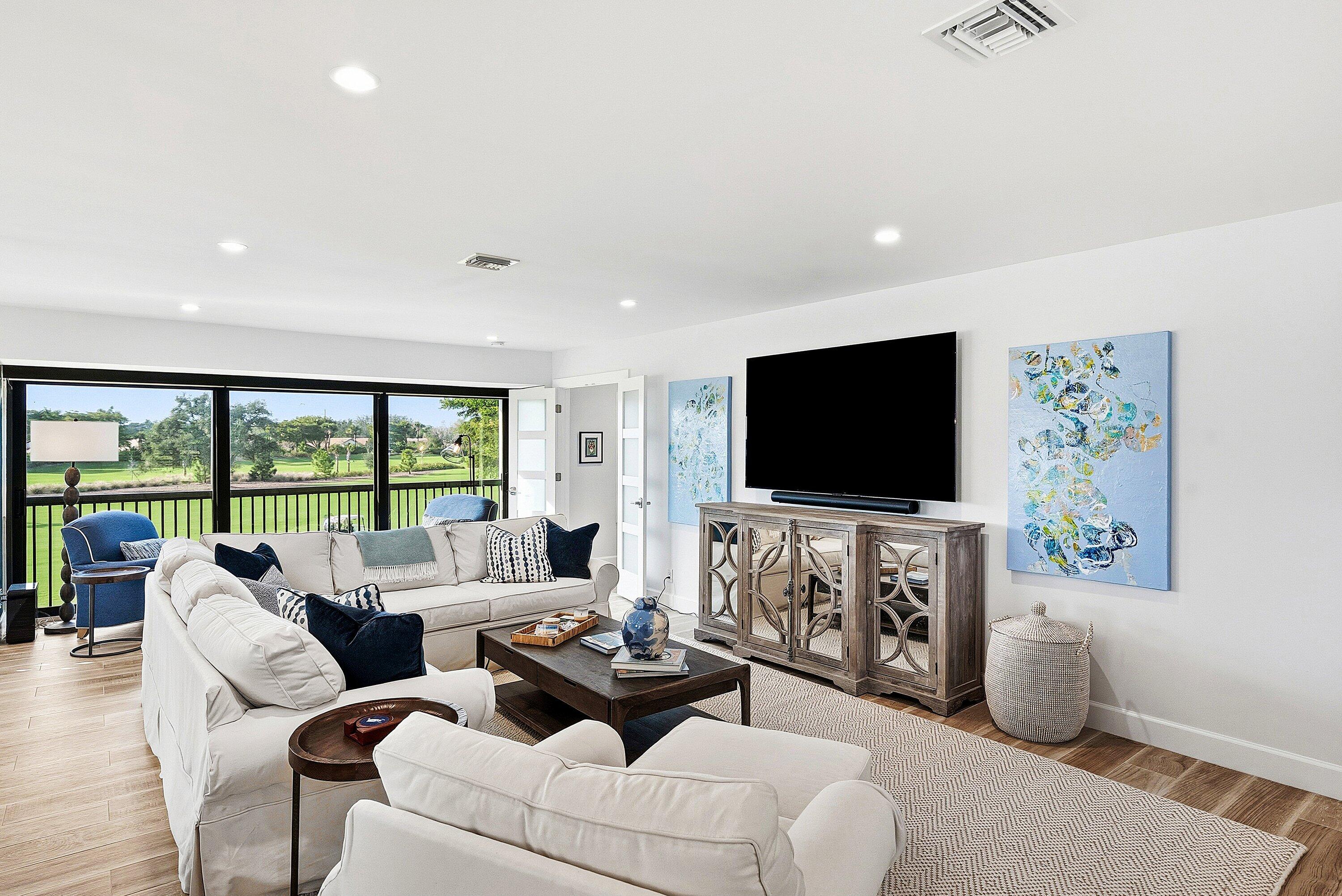 10157 Quail Covey Road, Unit HIBISCUS N Boynton Beach, FL 33436 - Photo 7 of 52 a living room with furniture and a flat screen tv