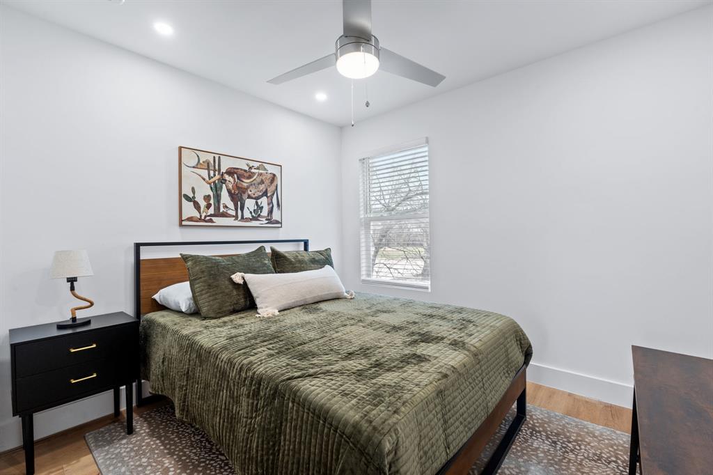 2706 Wheless Lane, Unit 401 Austin, TX 78723 - Photo 17 of 24 A tranquil bedroom with hardwood floors and ample natural illumination, perfect for unwinding.