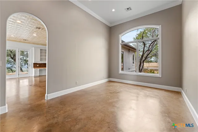 an empty room with windows and outdoor view