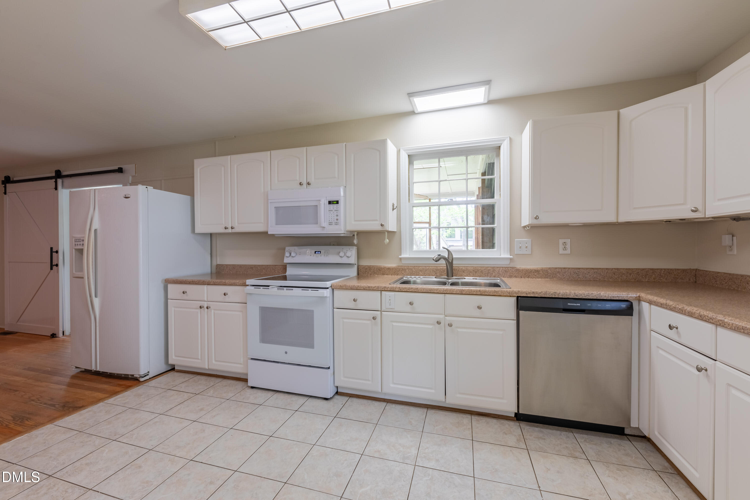 408 Ortega Road Raleigh, NC 27609 - Photo 6 of 25 a kitchen with cabinets appliances and a window