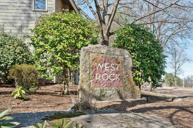 a sign that is sitting on a sidewalk