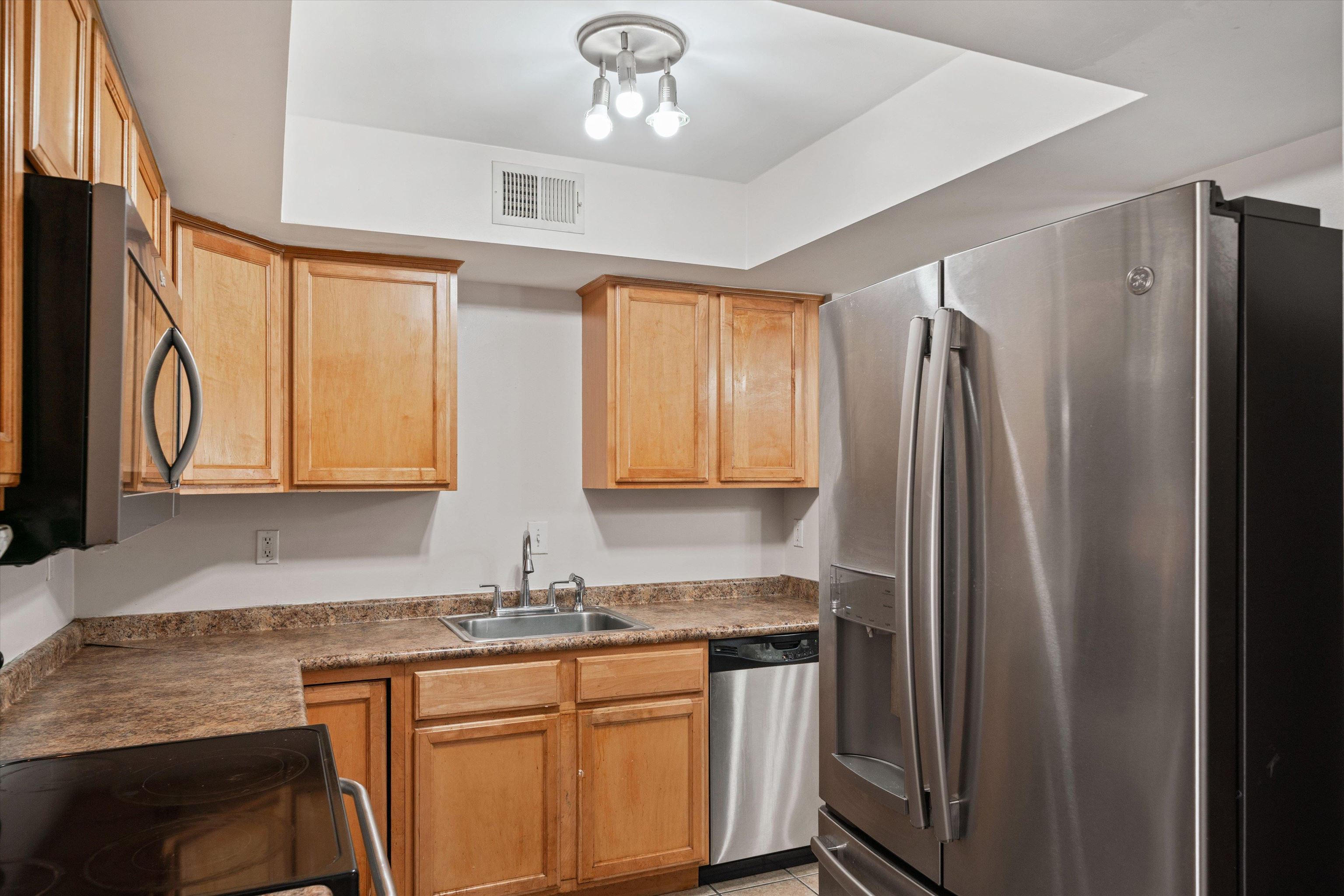 1838 Fernspring Cove, Unit 36 Germantown, TN 38138 - Photo 8 of 21 a kitchen with stainless steel appliances granite countertop a refrigerator and a sink