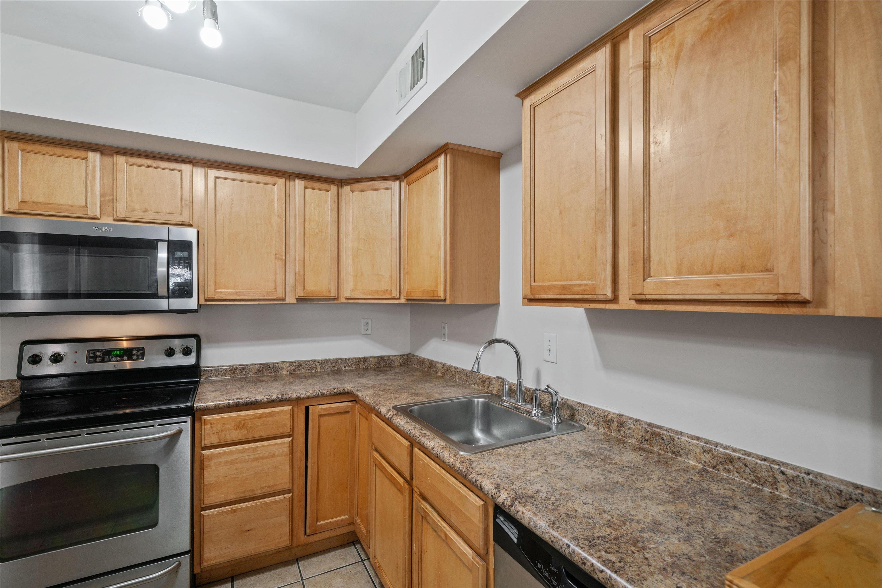 1838 Fernspring Cove, Unit 36 Germantown, TN 38138 - Photo 9 of 21 a kitchen with a sink stove and microwave