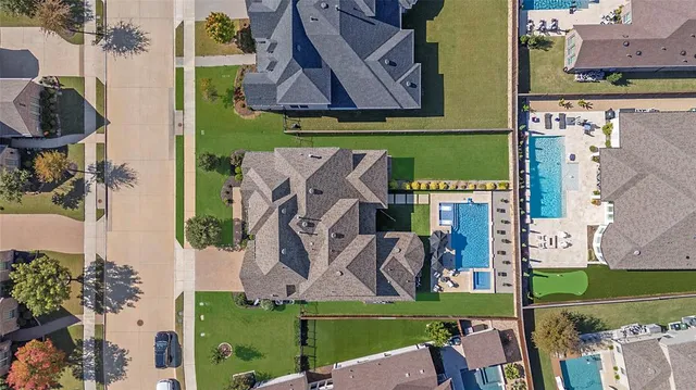 an aerial view of residential houses with outdoor space