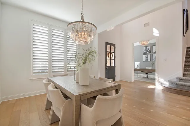 a view of a dining room with furniture wooden floor and chandelier
