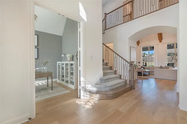 a view of a hallway with wooden floor and staircase