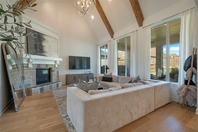 a living room with furniture fireplace and flat screen tv