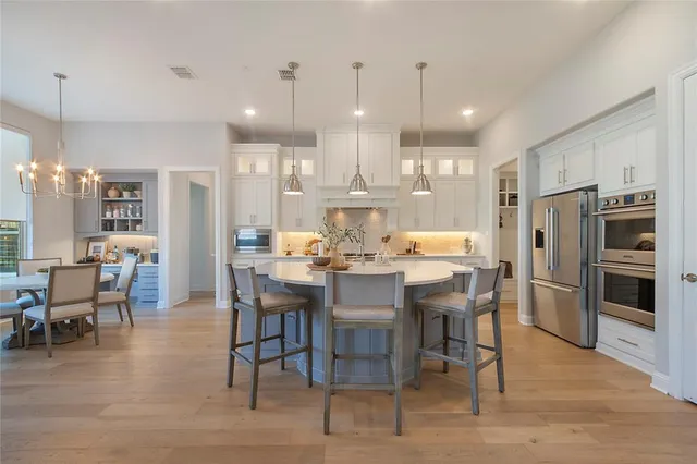a large kitchen with a table and chairs