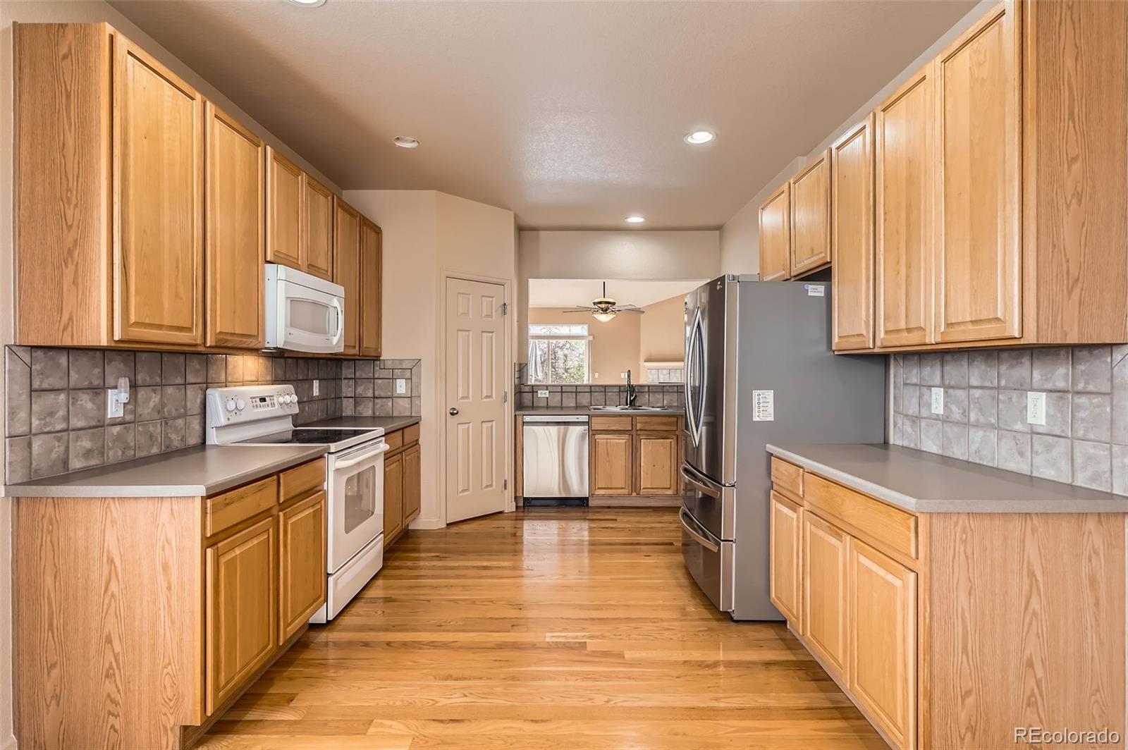 1978 Granger Circle Castle Rock, CO 80109 - Photo 12 of 31 a kitchen with stainless steel appliances a refrigerator sink and cabinets