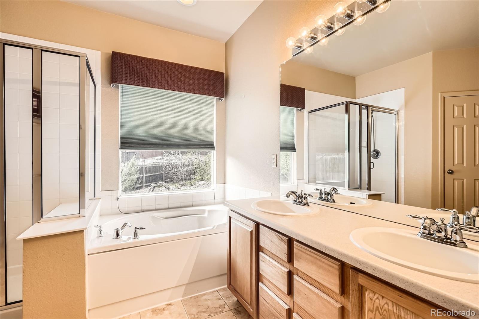 1978 Granger Circle Castle Rock, CO 80109 - Photo 18 of 31 a bathroom with a tub sink and mirror