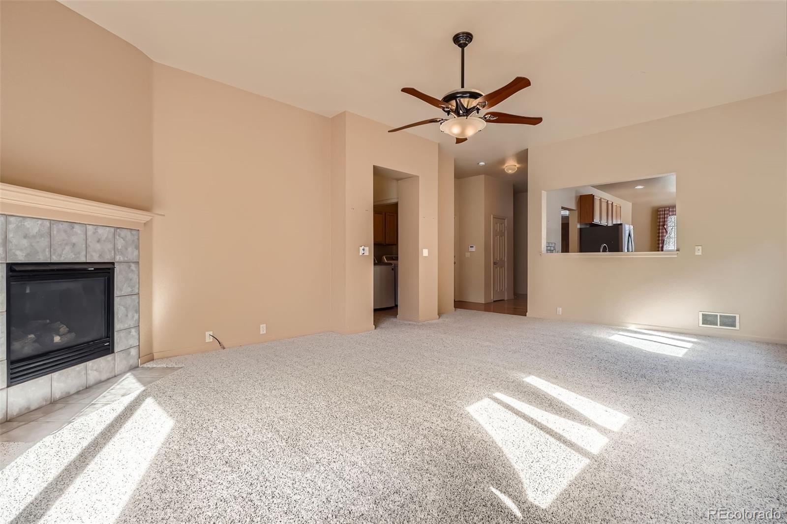 1978 Granger Circle Castle Rock, CO 80109 - Photo 8 of 31 a view of a livingroom with a chandelier fan and a fireplace
