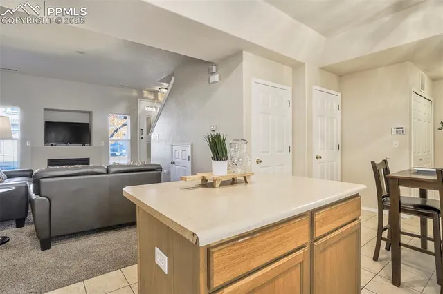 a kitchen with kitchen island a sink table and chairs