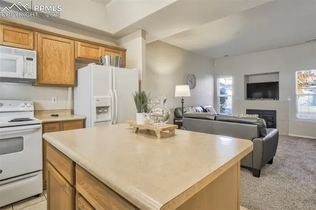 a view of kitchen with stainless steel appliances granite countertop a sink a stove and refrigerator