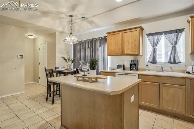 a kitchen with sink a window and chairs