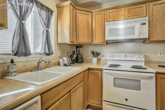 a kitchen with stainless steel appliances a stove a sink and a microwave