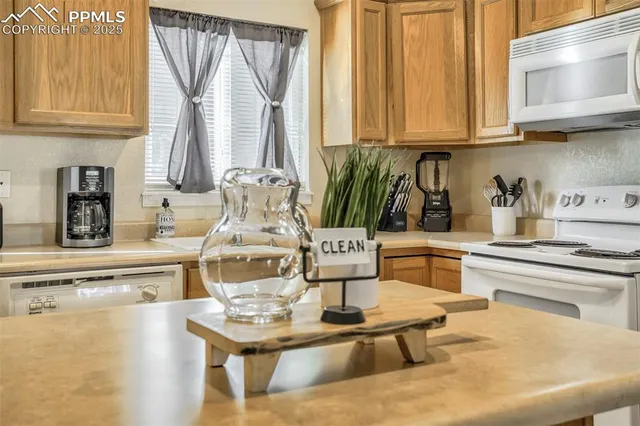 a kitchen with a stove a sink and a white cabinets