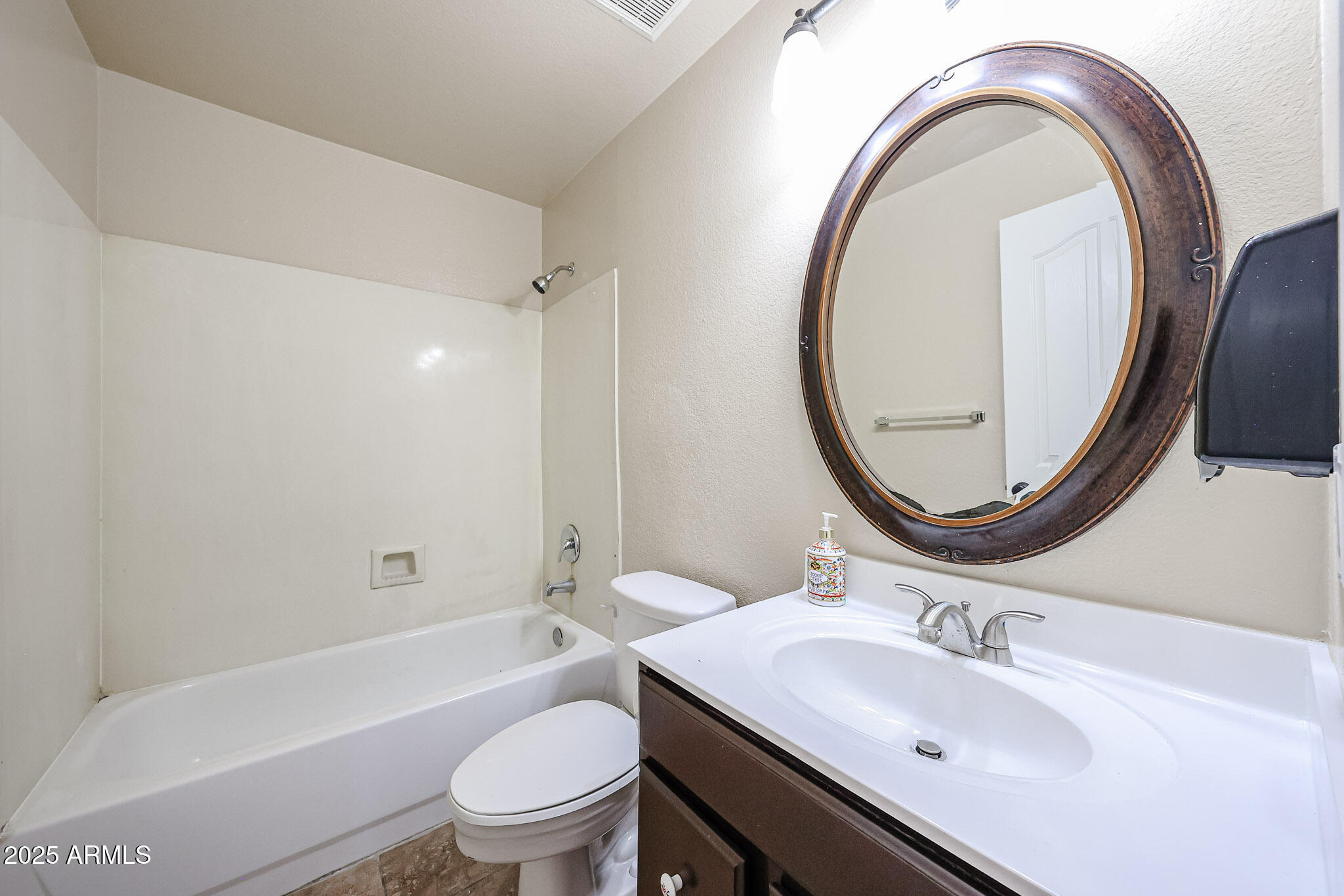 3897 East Douglas Loop Gilbert, AZ 85234 - Photo 20 of 34 a bathroom with a sink a toilet and a mirror