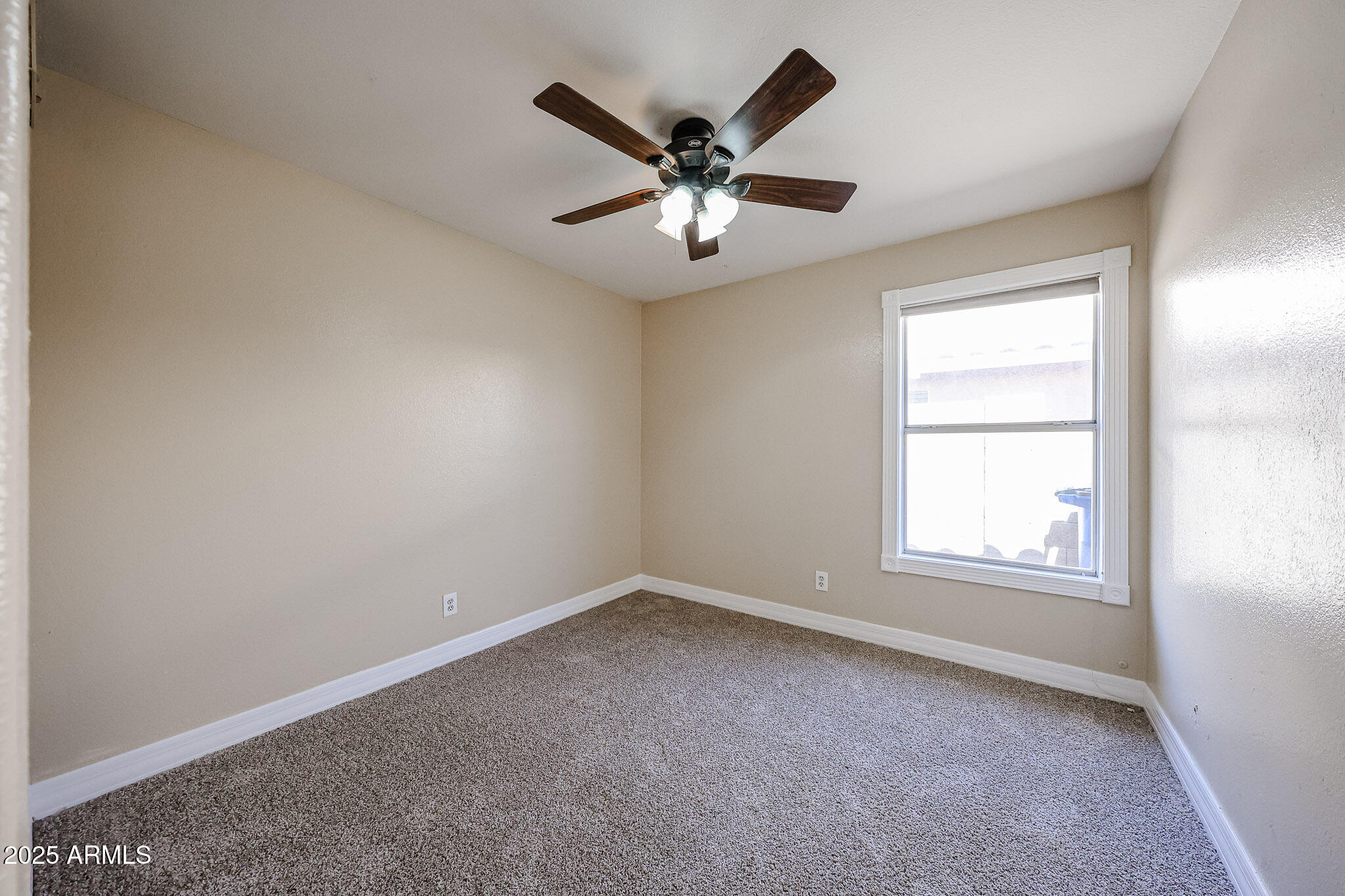 3897 East Douglas Loop Gilbert, AZ 85234 - Photo 25 of 34 an empty room with window and ceiling fan