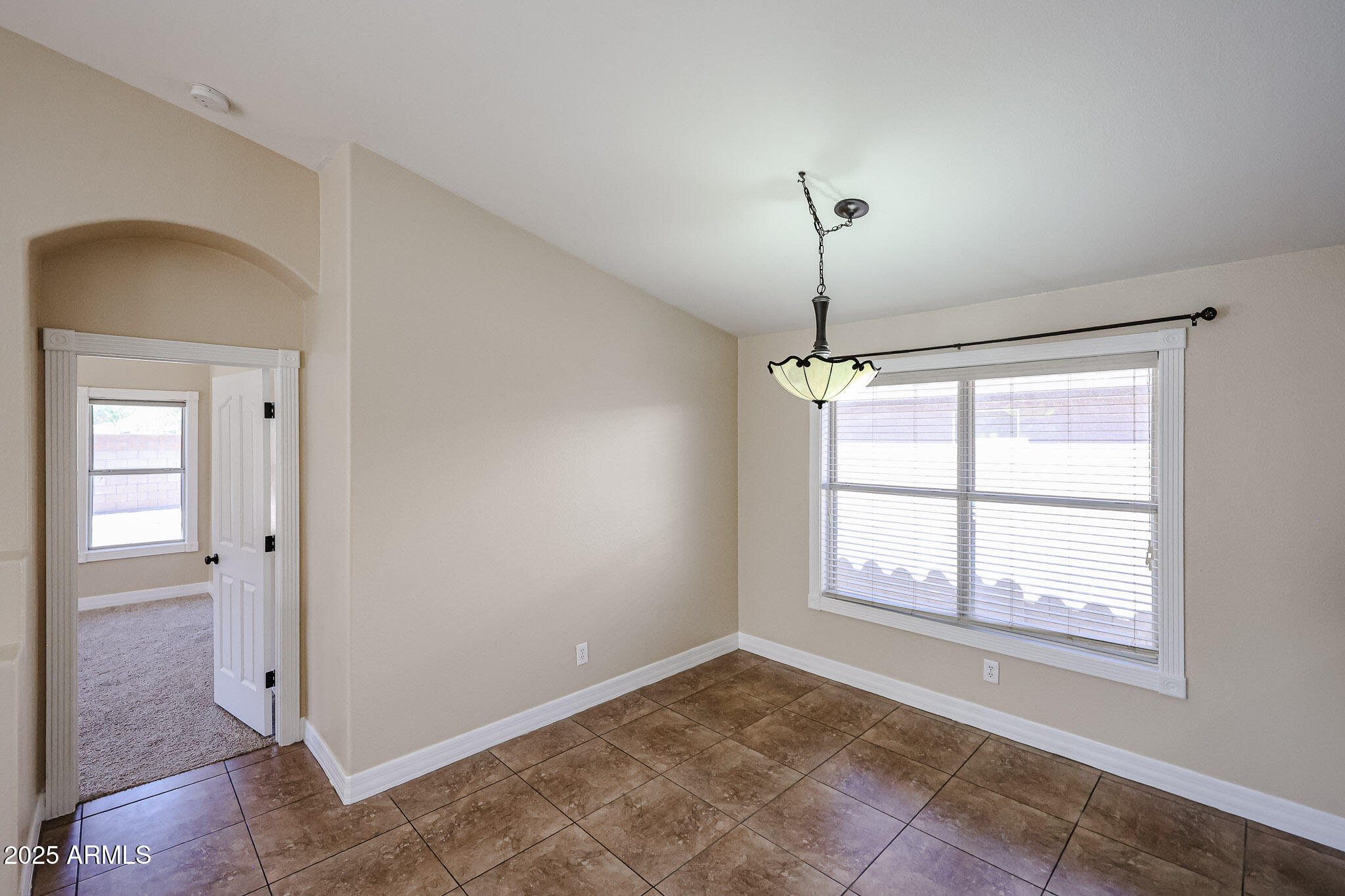 3897 East Douglas Loop Gilbert, AZ 85234 - Photo 7 of 34 a view of an empty room with a window