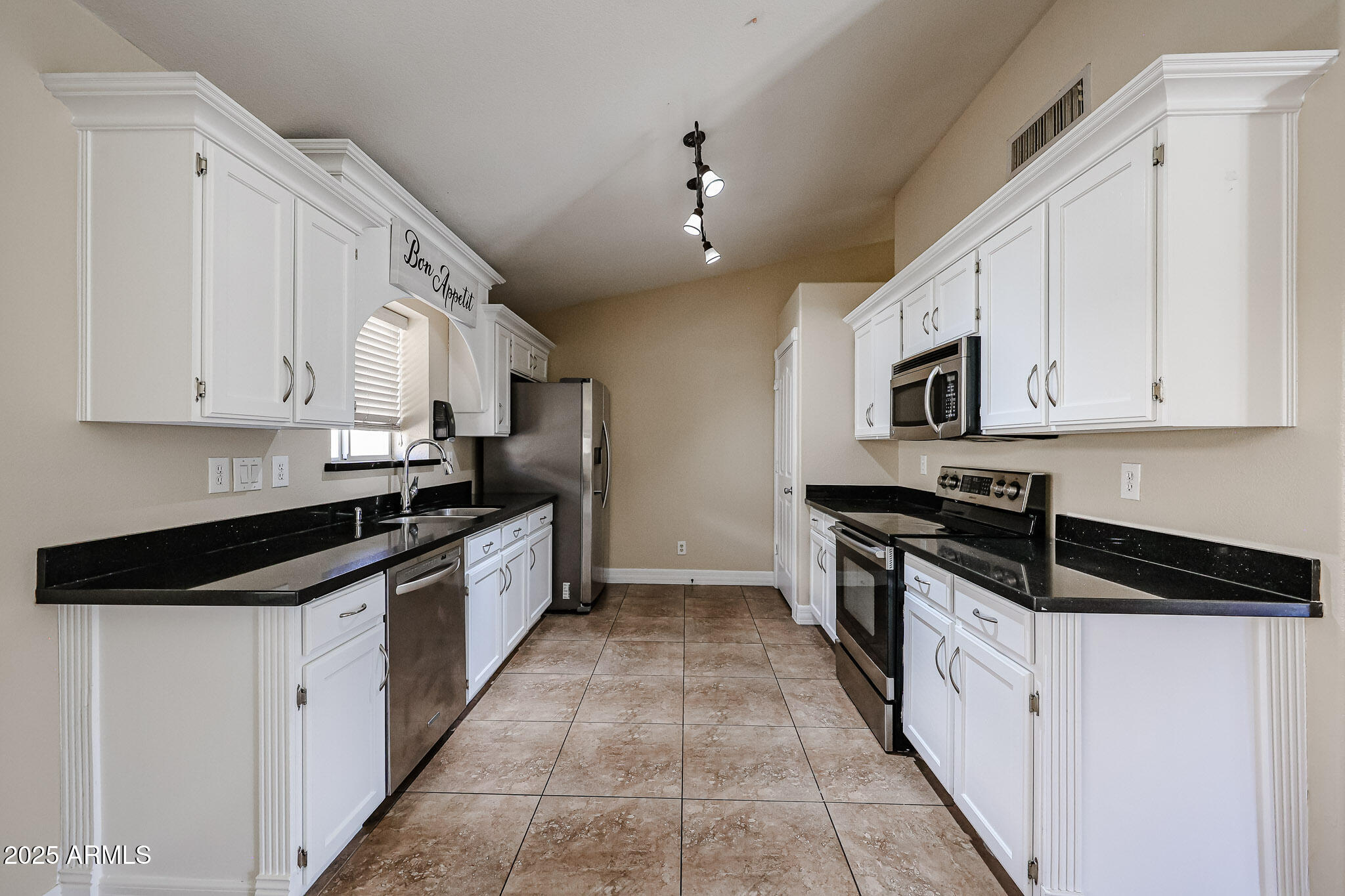 3897 East Douglas Loop Gilbert, AZ 85234 - Photo 9 of 34 a large white kitchen with stainless steel appliances
