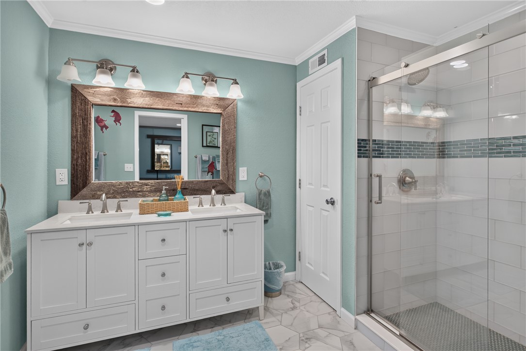 351 River Road Westminster, SC 29693 - Photo 37 of 50 A well-appointed bath features a double vanity and a sleek glass-enclosed shower.