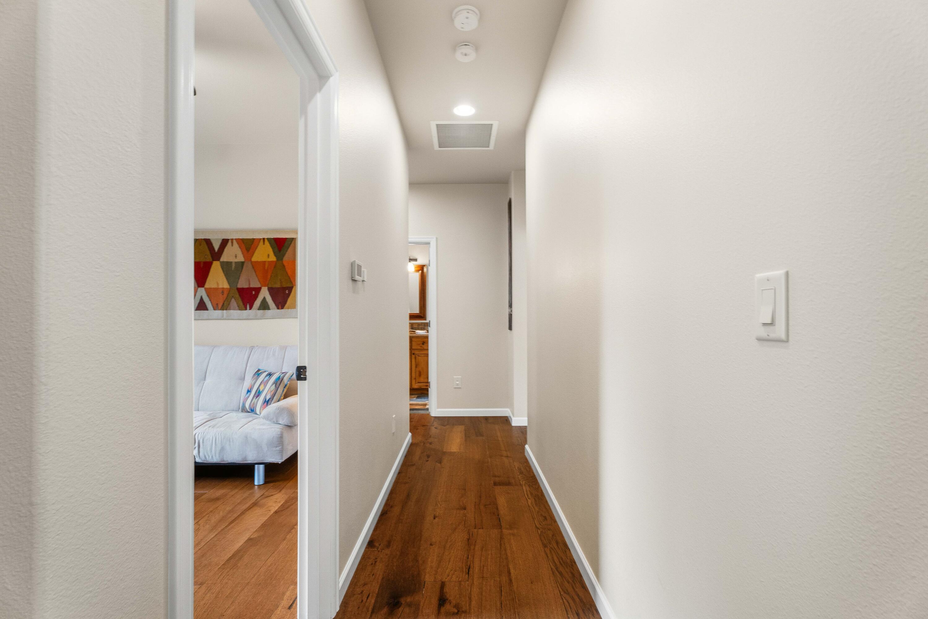 205 Vista Rim Drive Redmond, OR 97756 - Photo 18 of 85 a view of a hallway view with wooden floor and furniture