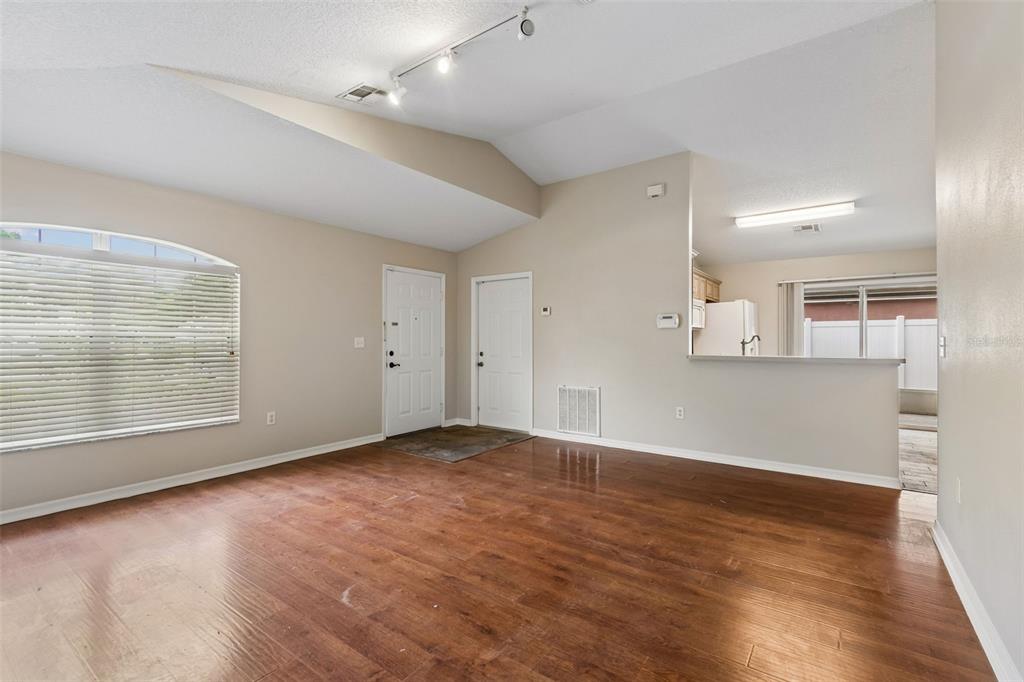 4631 Eagle Ranch Drive Zephyrhills, FL 33542 - Photo 11 of 58 an empty room with wooden floor and windows