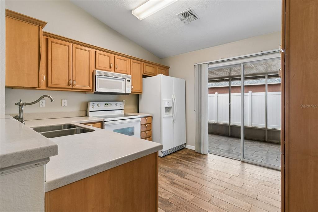4631 Eagle Ranch Drive Zephyrhills, FL 33542 - Photo 13 of 58 a kitchen with a refrigerator a stove and a sink