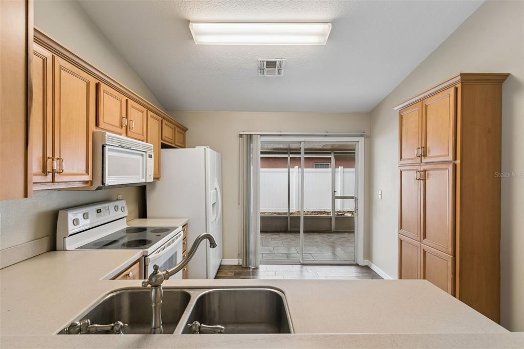 4631 Eagle Ranch Drive Zephyrhills, FL 33542 - Photo 15 of 58 a room with a sink and a refrigerator