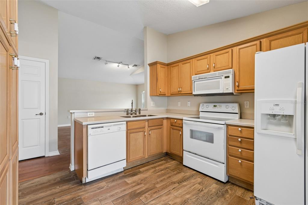 4631 Eagle Ranch Drive Zephyrhills, FL 33542 - Photo 16 of 58 a kitchen with stainless steel appliances granite countertop a stove a sink and a refrigerator