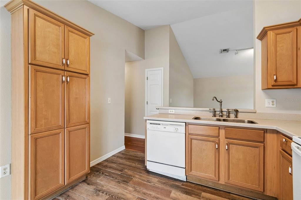 4631 Eagle Ranch Drive Zephyrhills, FL 33542 - Photo 17 of 58 a kitchen with white cabinets and white appliances