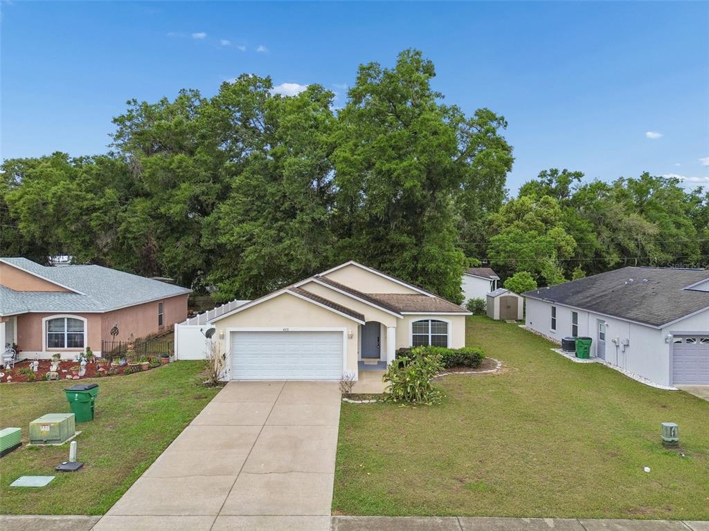 4631 Eagle Ranch Drive Zephyrhills, FL 33542 - Photo 43 of 58 a front view of a house with garden