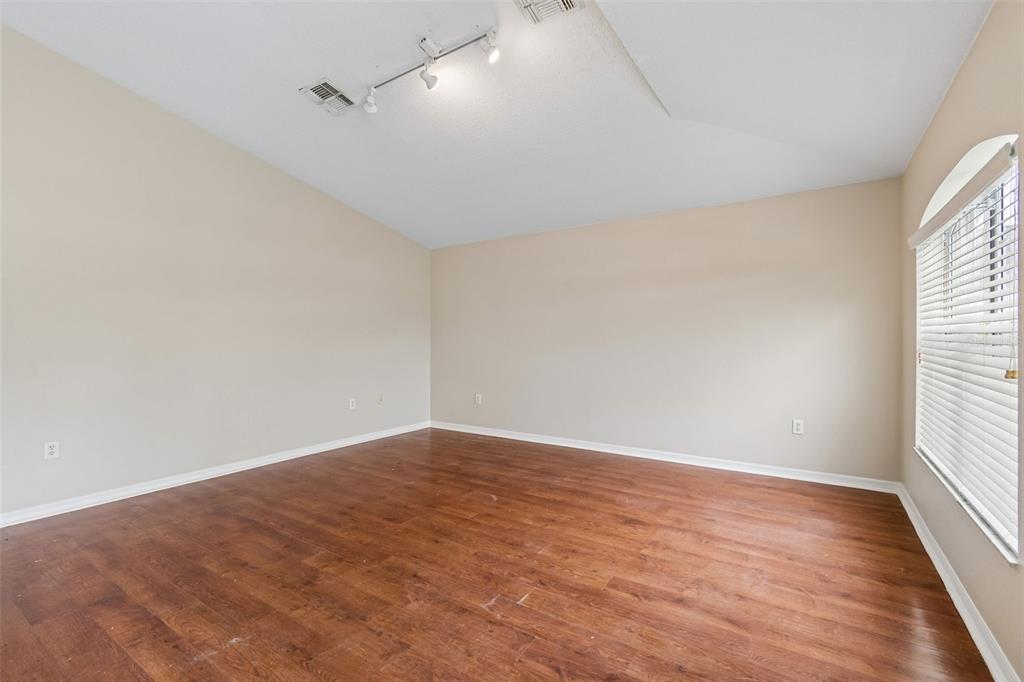 4631 Eagle Ranch Drive Zephyrhills, FL 33542 - Photo 9 of 58 wooden floor in an empty room with a window