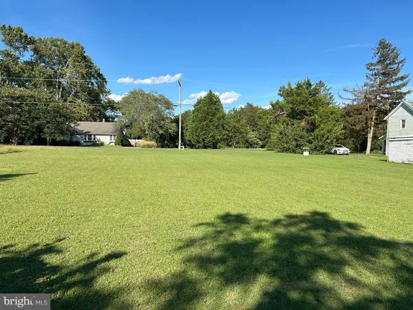 a view of a field with an ocean view