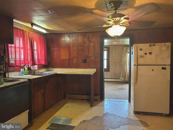 a kitchen with a refrigerator and a sink