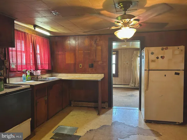 a kitchen with a refrigerator and a sink