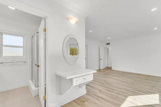 a view of a hallway with wooden floor
