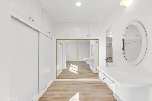 a view of a hallway with wooden floor and entryway