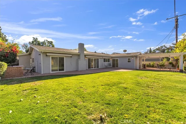 a swimming pool with outdoor seating and yard